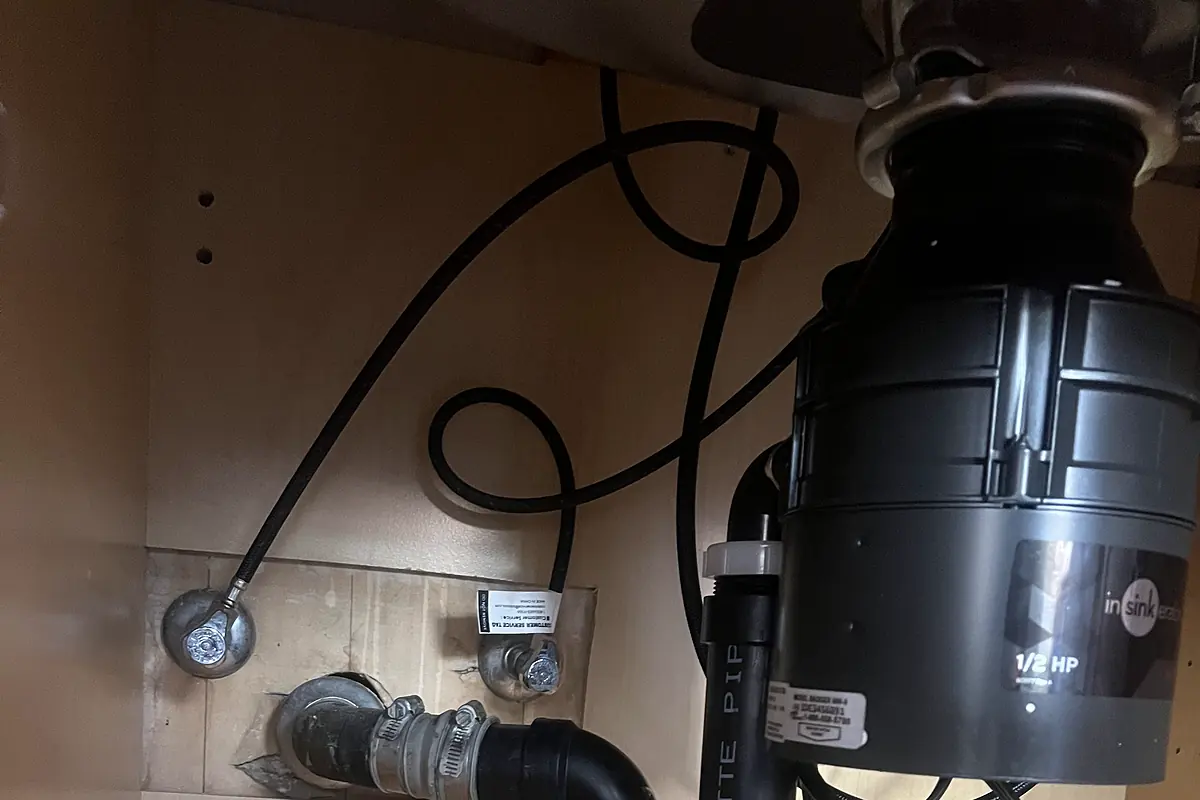 A new 1/2 HP garbage disposal installed and plumbed under the sink.